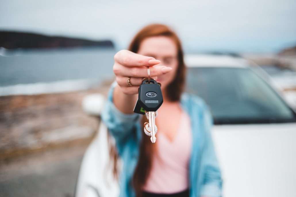 woman holding a car key